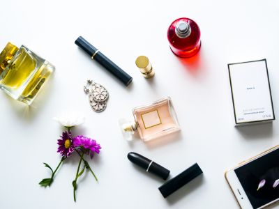 Makeup tools for professional makeup artist. Makeup brushes. Airbrush and jar of paint. Makeup tools and accessory on concrete gray background. Fashion and beauty concept.